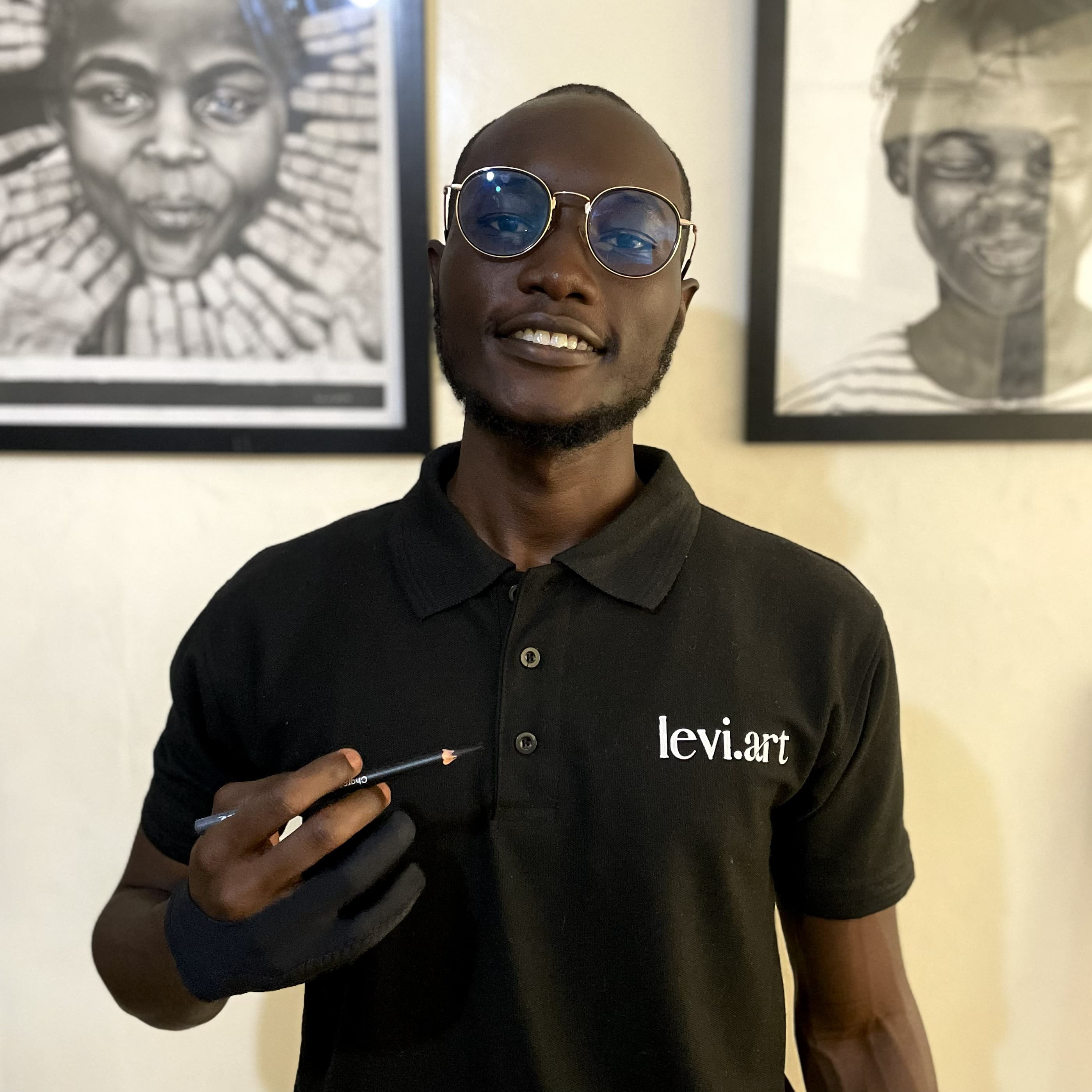 Levi, charcoal portrait artist, in his studio