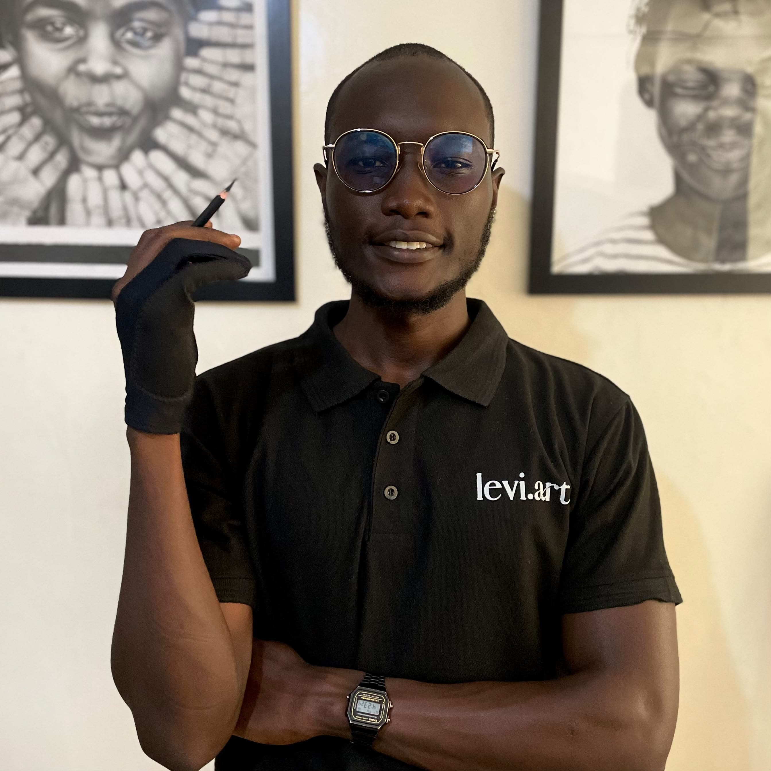 Levi, charcoal portrait artist, in his studio